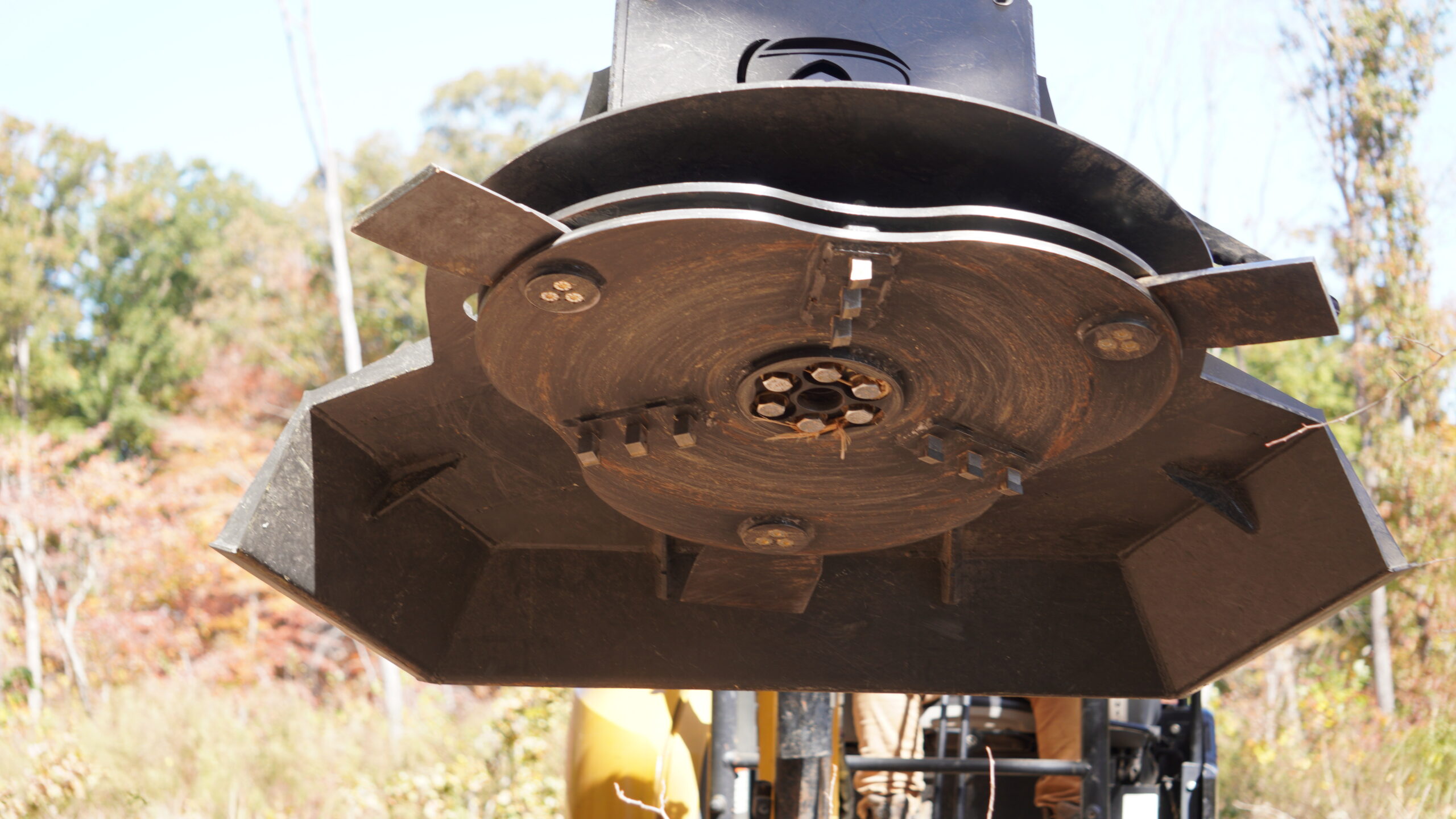 Commercial and government skid steer and excavator attachments from CID, including swing boom brush cutters, grapples, buckets, and severe duty vegetation management equipment for municipal, DOT, forestry, and commercial fleet operations.