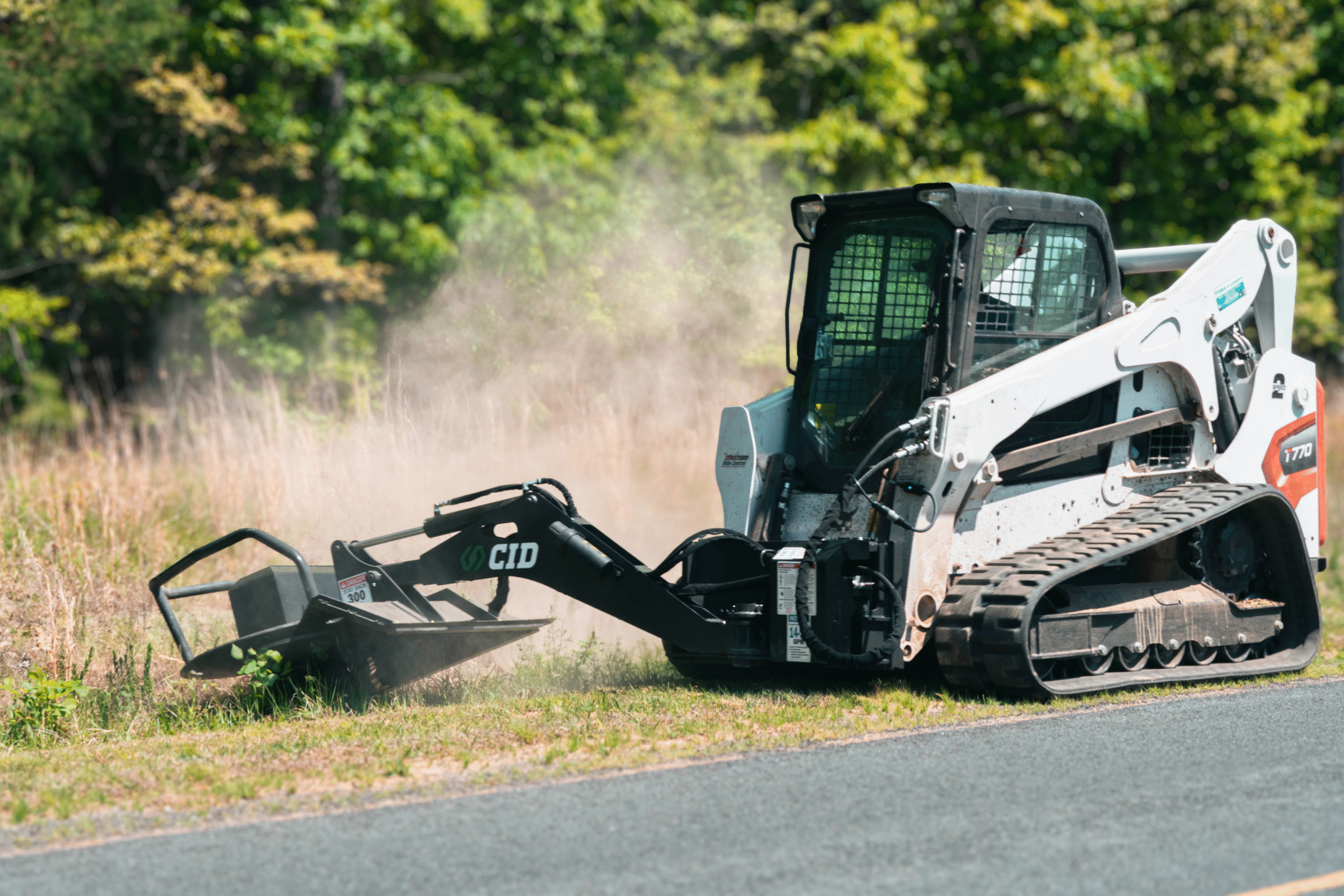 Commercial and government skid steer and excavator attachments from CID, including swing boom brush cutters, grapples, buckets, and severe duty vegetation management equipment for municipal, DOT, forestry, and commercial fleet operations.