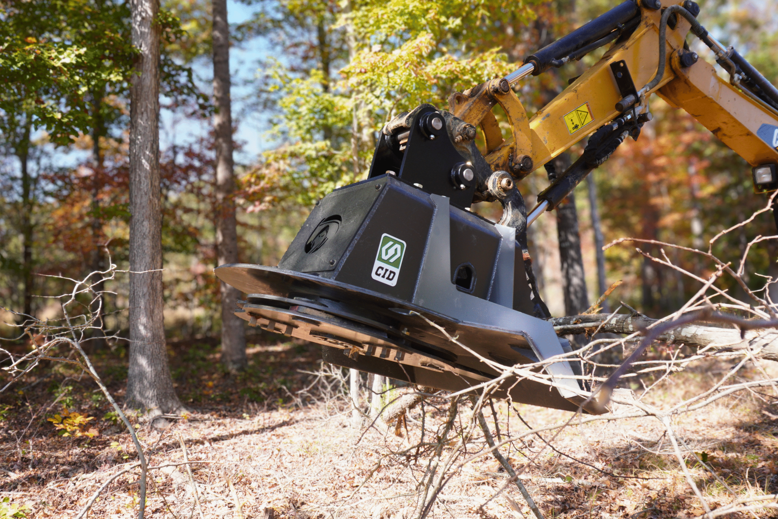 Commercial and government skid steer and excavator attachments from CID, including swing boom brush cutters, grapples, buckets, and severe duty vegetation management equipment for municipal, DOT, forestry, and commercial fleet operations.